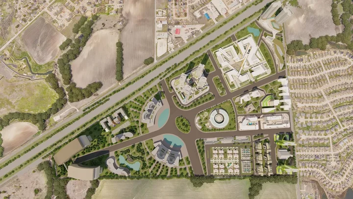 Aerial site development rendering showing roads, building clusters, landscaping, and circulation